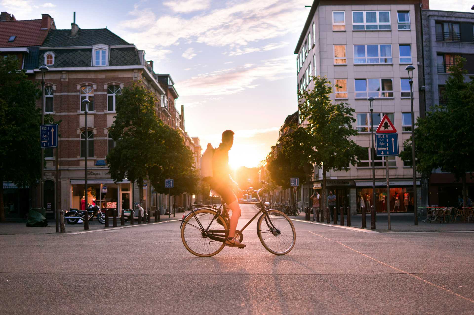 Man riding bicycle on road during daytime